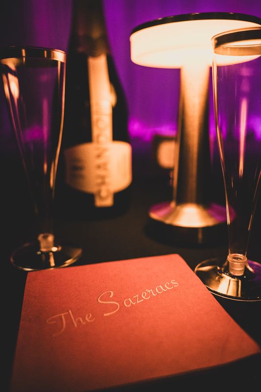 Table setting with a Sazerac and the show program